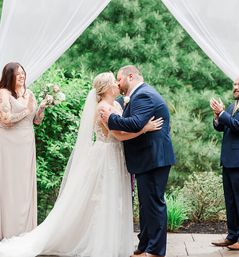 bride groom first kiss outdoor ceremony