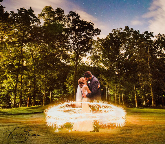 bride groom kissing dusk sparklers