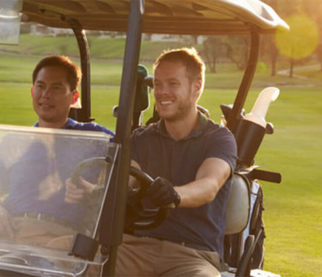 golfers driving golf cart