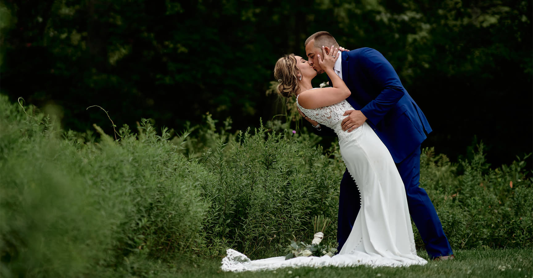 bride groom kissing outside landscape